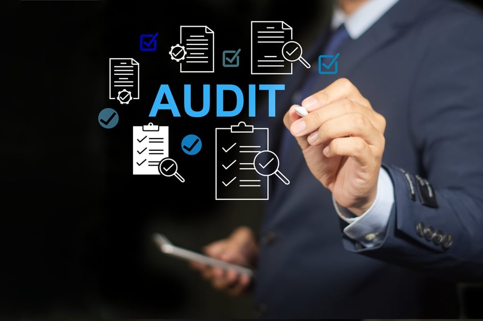 An auditor reviewing compliance documentation