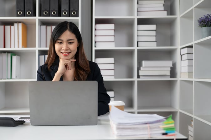HR manager at her desk setting up an employee payroll giving scheme
