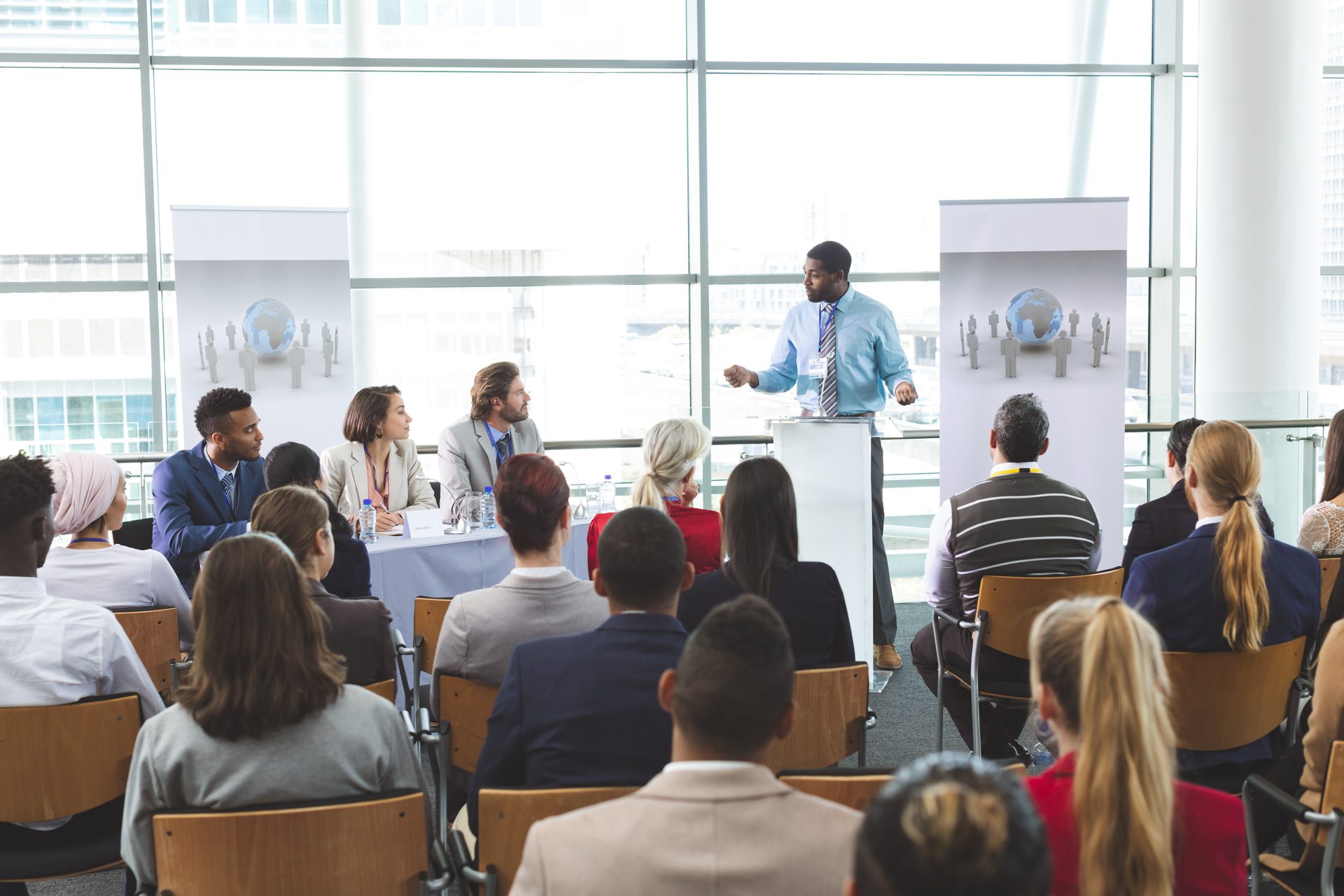 A speaker addressing an audience at a business seminar