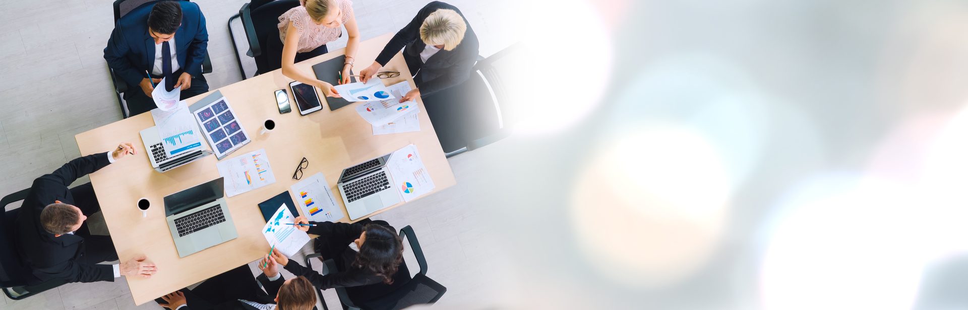 An overhead view of a team meeting in an open-plan office