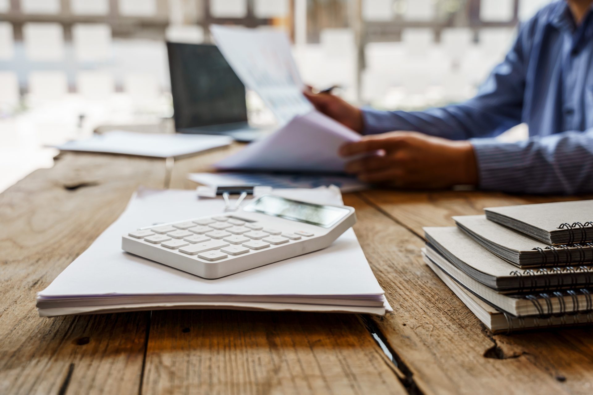 A finance team member checking figures on a printed report