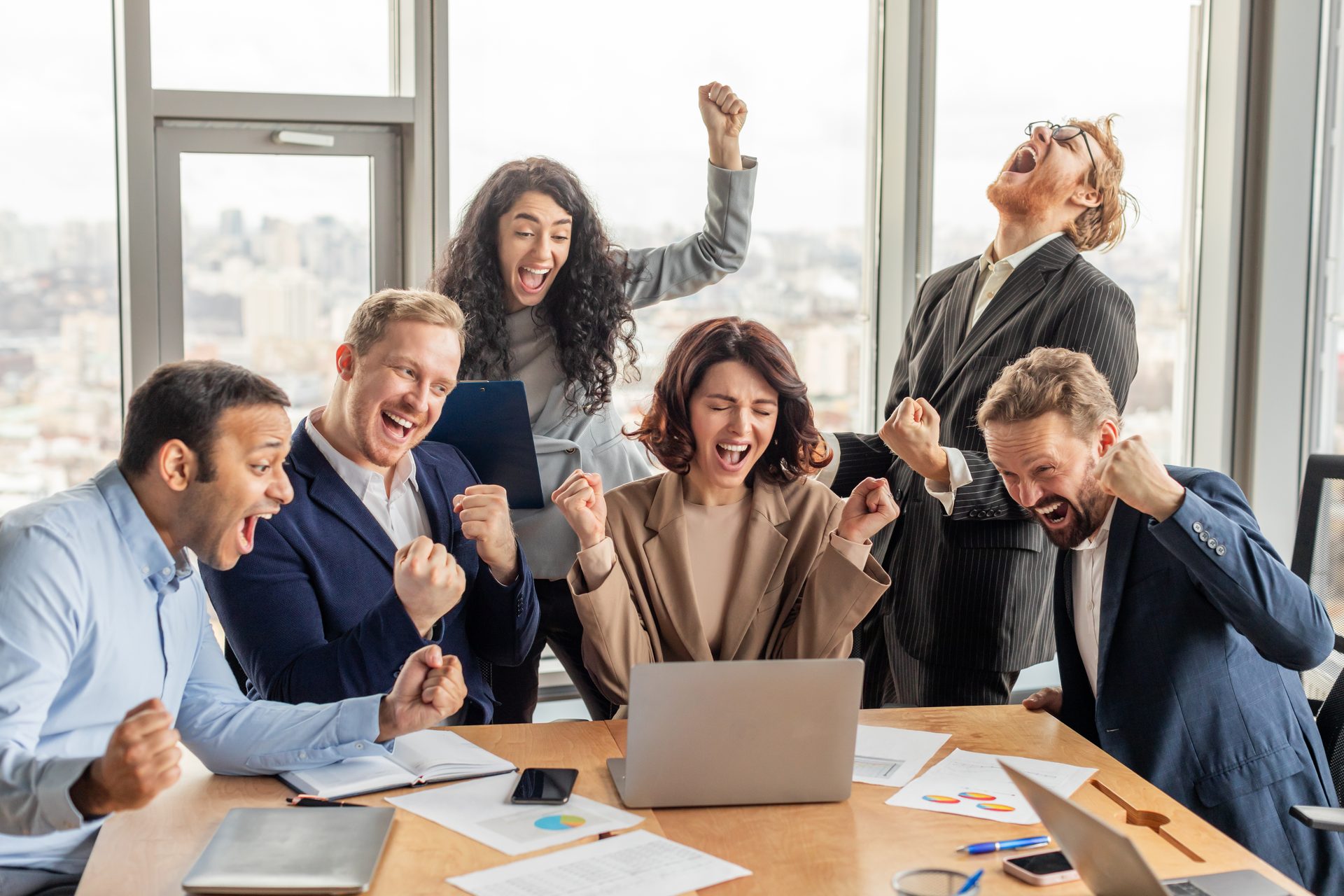 A diverse team celebrating a result in a modern office