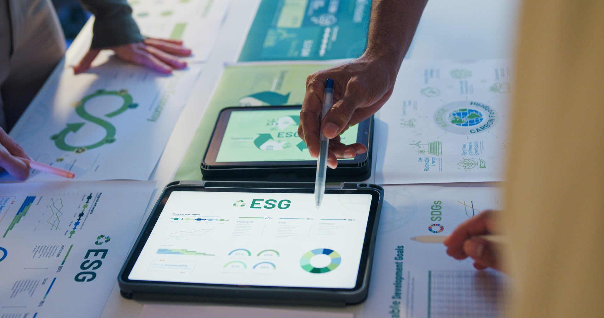 Colleagues discussing ESG strategy around a boardroom table